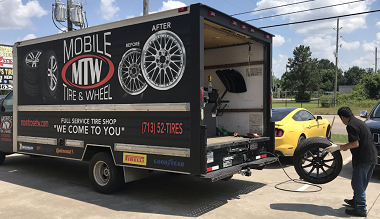 MTW mobile tire service truck with technician working on tire